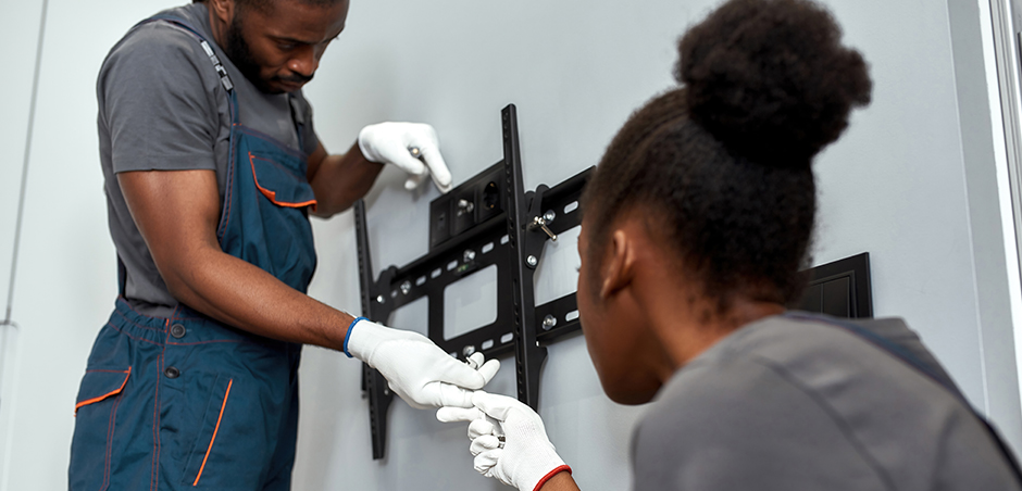 Installing tv Two people installing tv mount